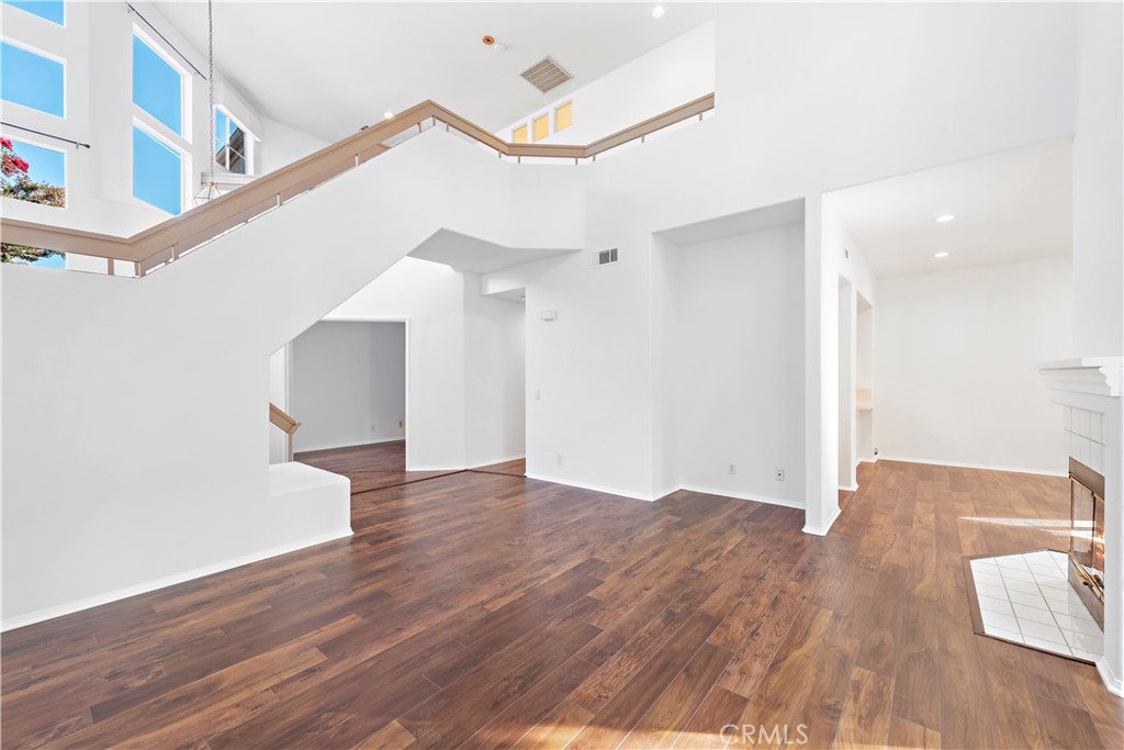 Large vaulted ceilings and ample natural light creates a dramatic living room space with gas fireplace.