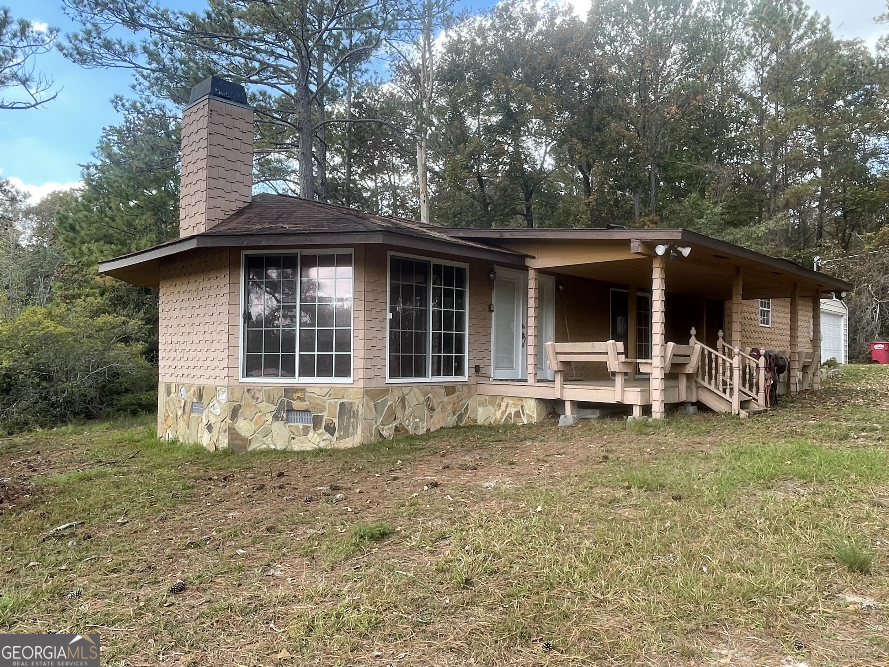 a front view of a house with a yard and seating space