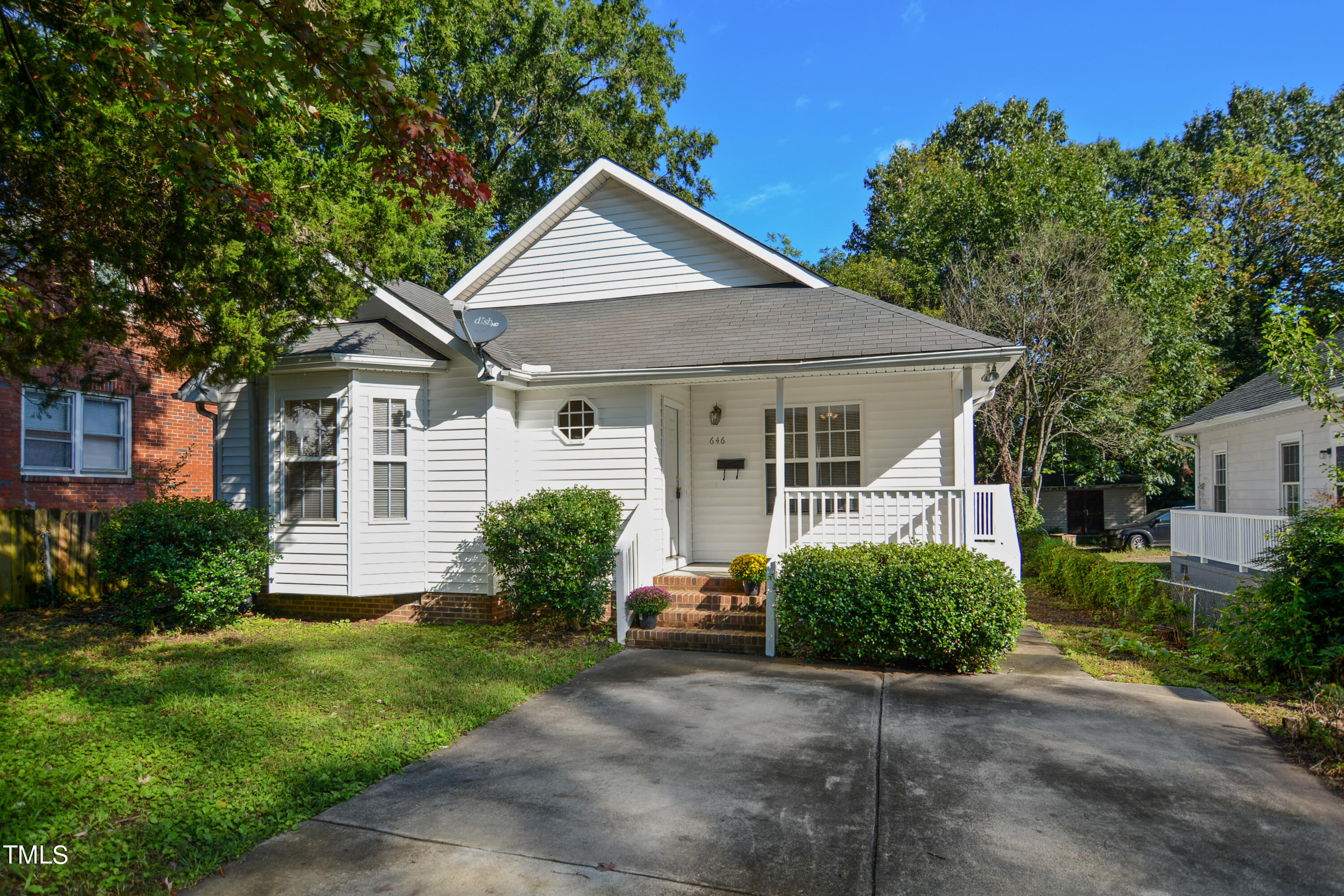 a front view of a house with a yard and plants