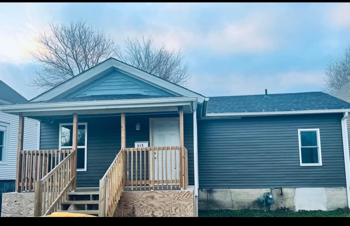 a view of a house with wooden fence