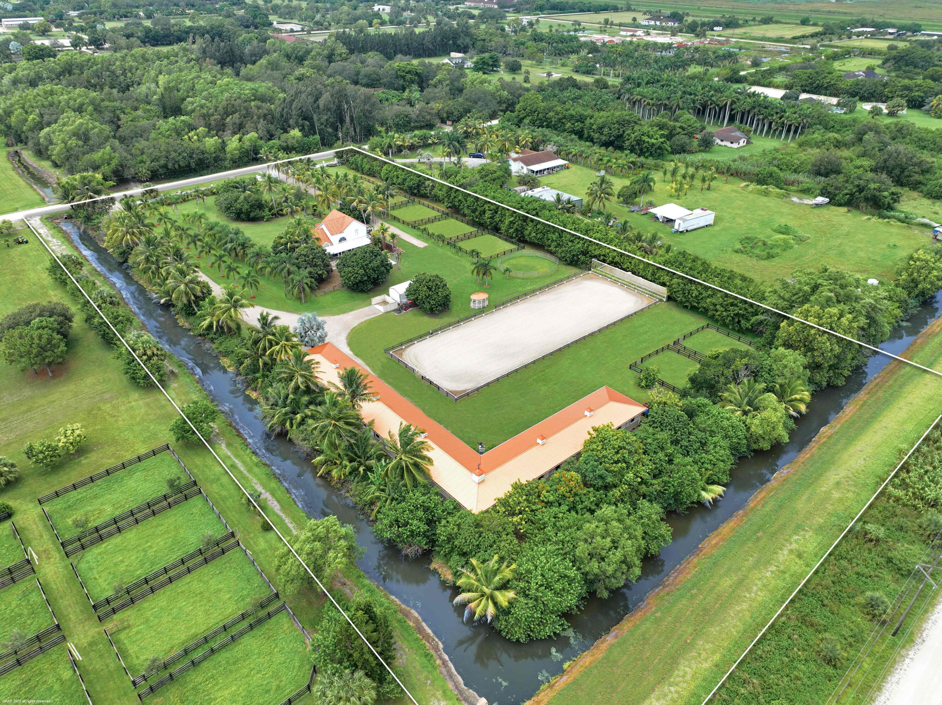 a view of a green yard with a lake view