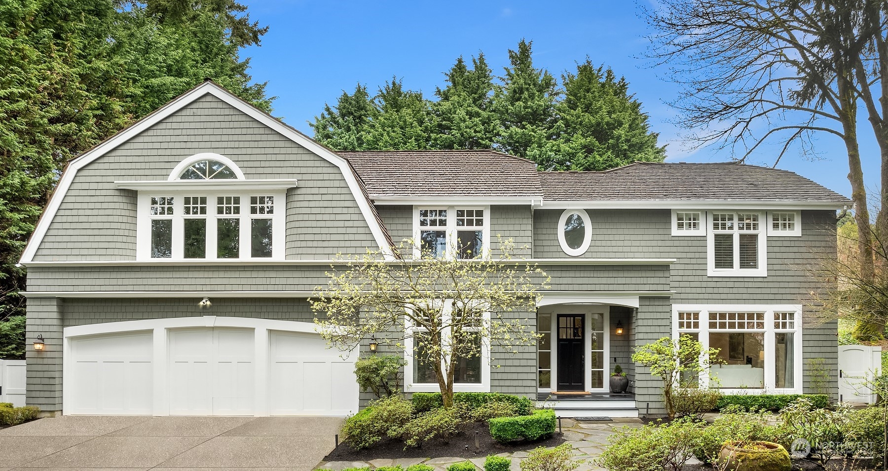 a front view of a house with a garden