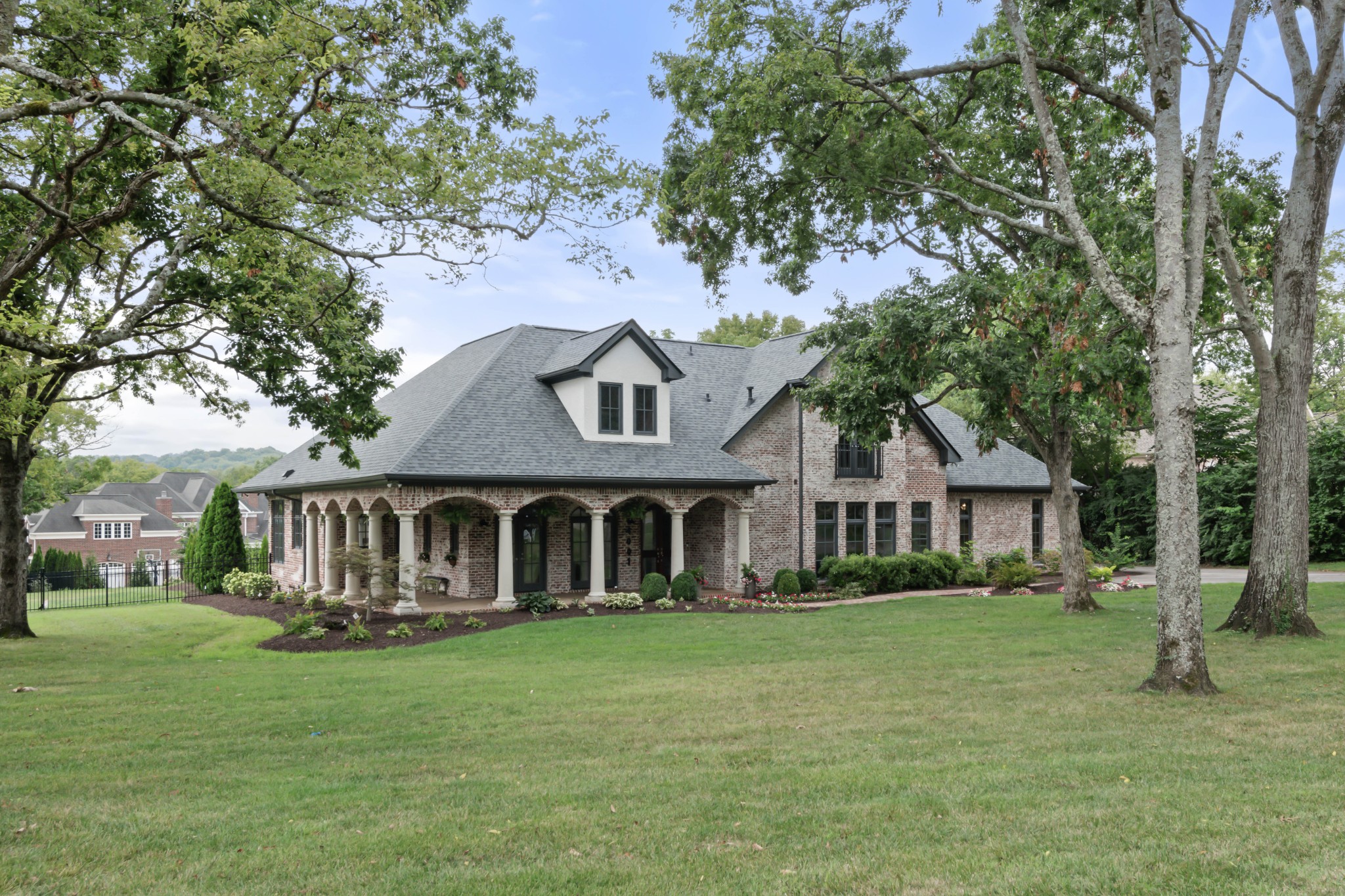 a front view of a house with a garden