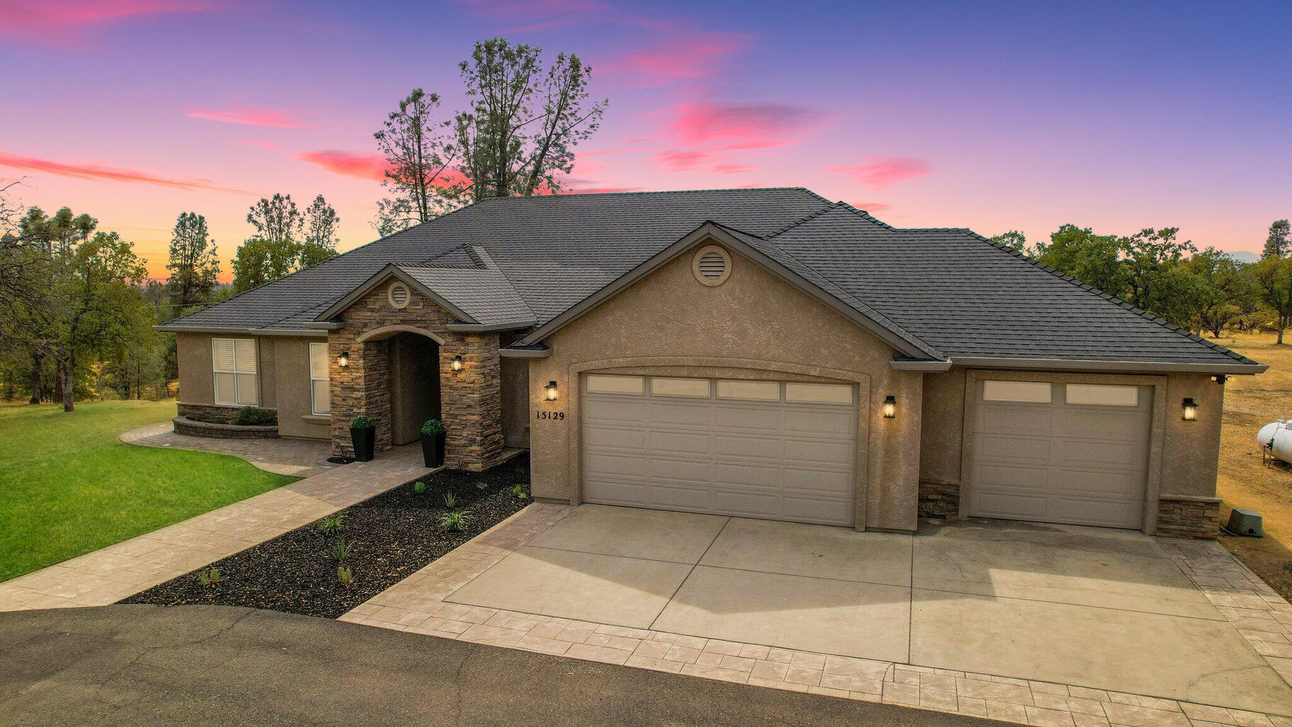 a front view of a house with a yard and garage