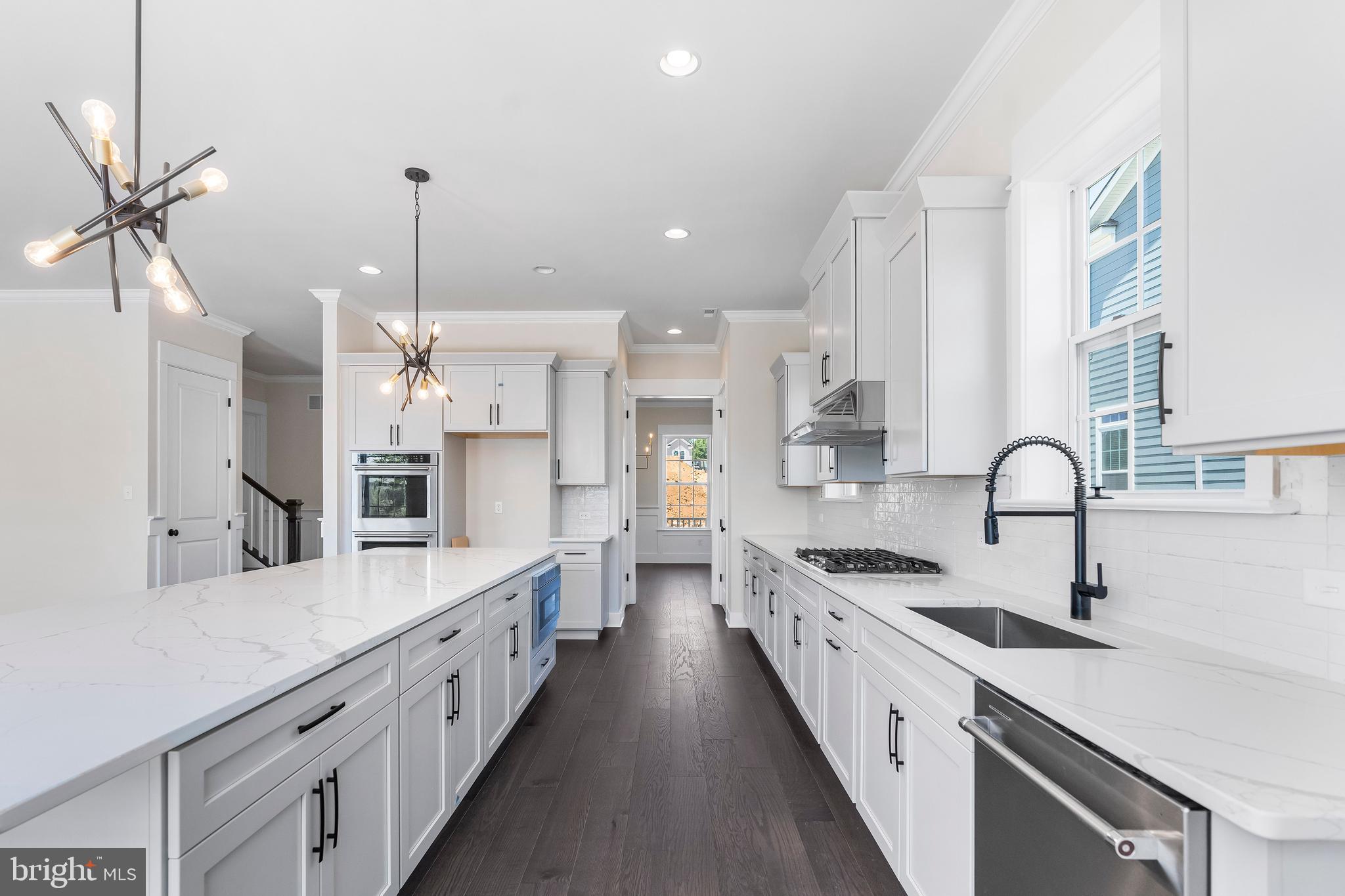 a large kitchen with stainless steel appliances kitchen island a large island in the center