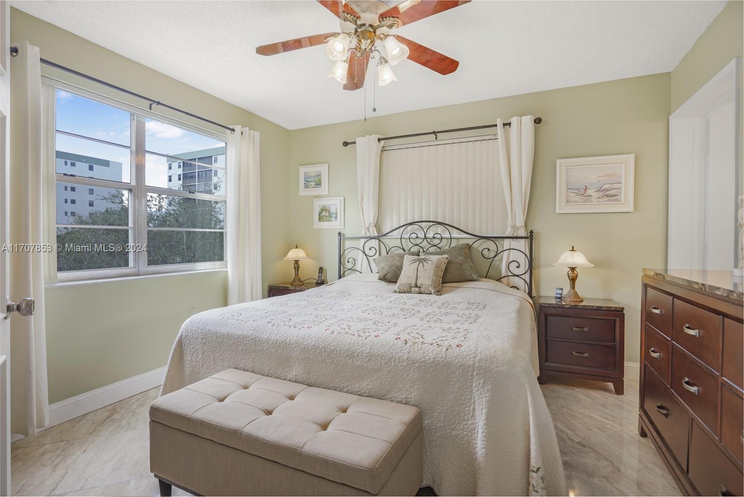 a bedroom with a bed and window with lamp