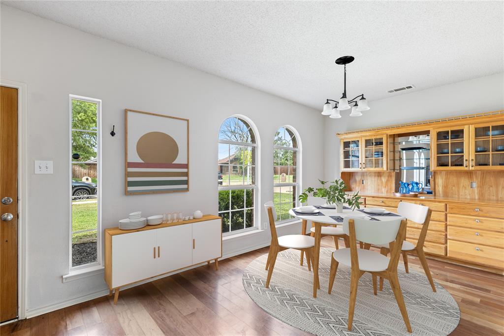 a view of a dining room with furniture window and wooden floor