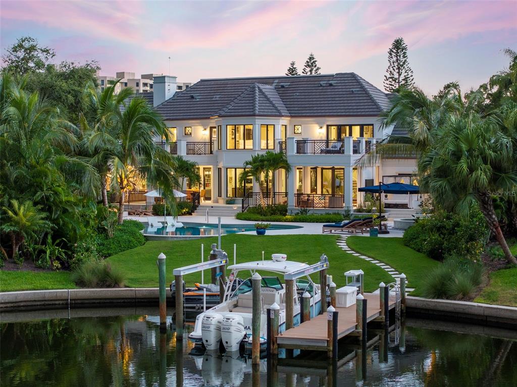 a front view of a house with swimming pool garden and patio