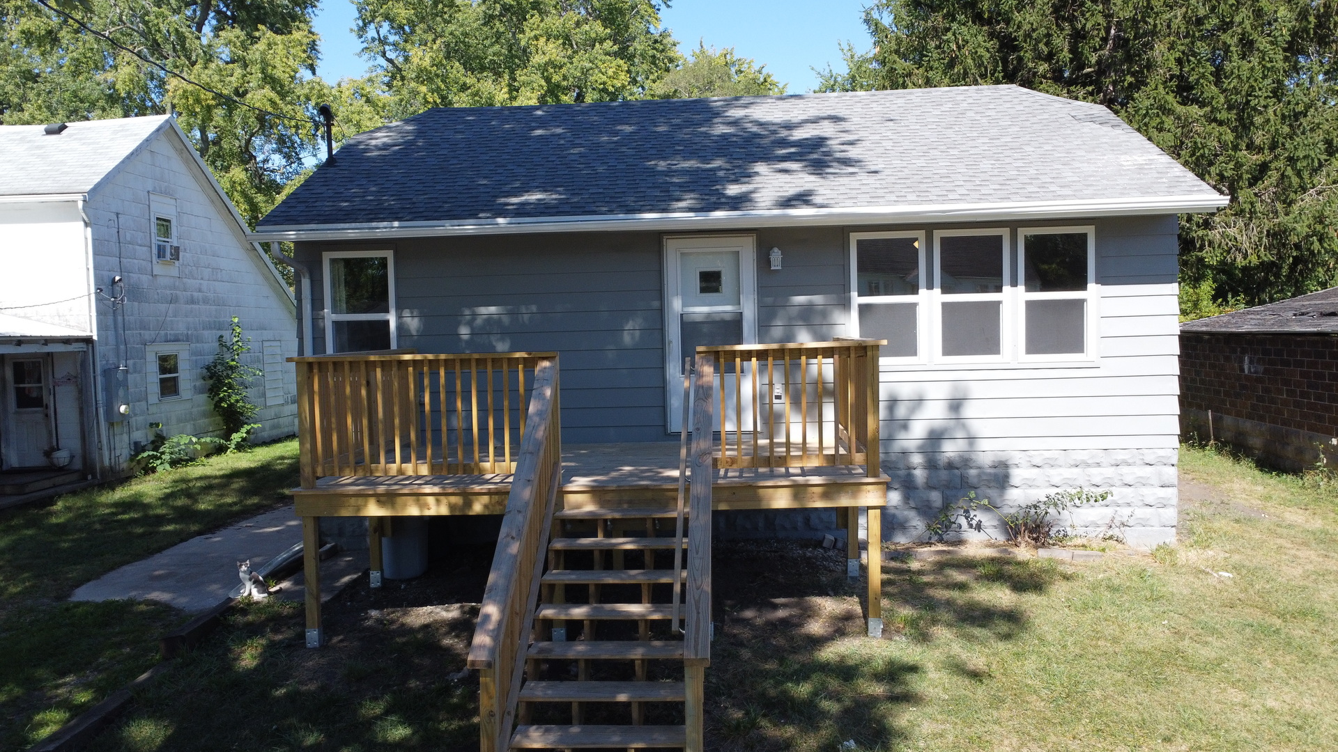 a front view of house with yard outdoor seating and barbeque oven