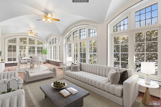 a living room with furniture a chandelier and a table