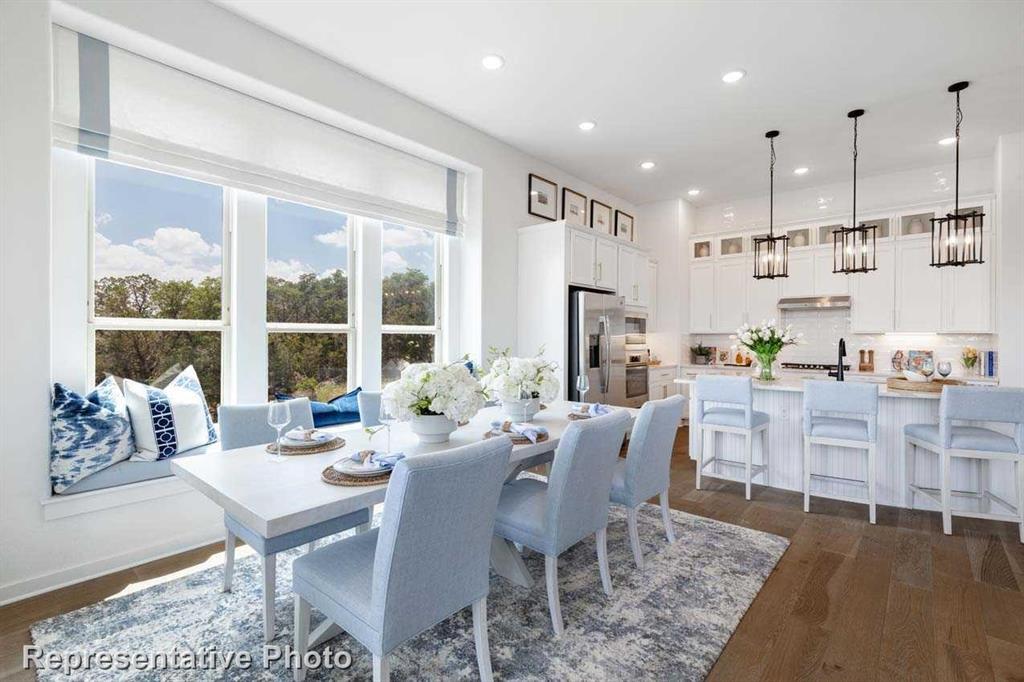 a view of a dining room with furniture large windows and wooden floor