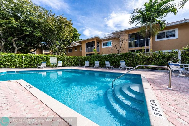 a view of house with swimming pool outdoor seating