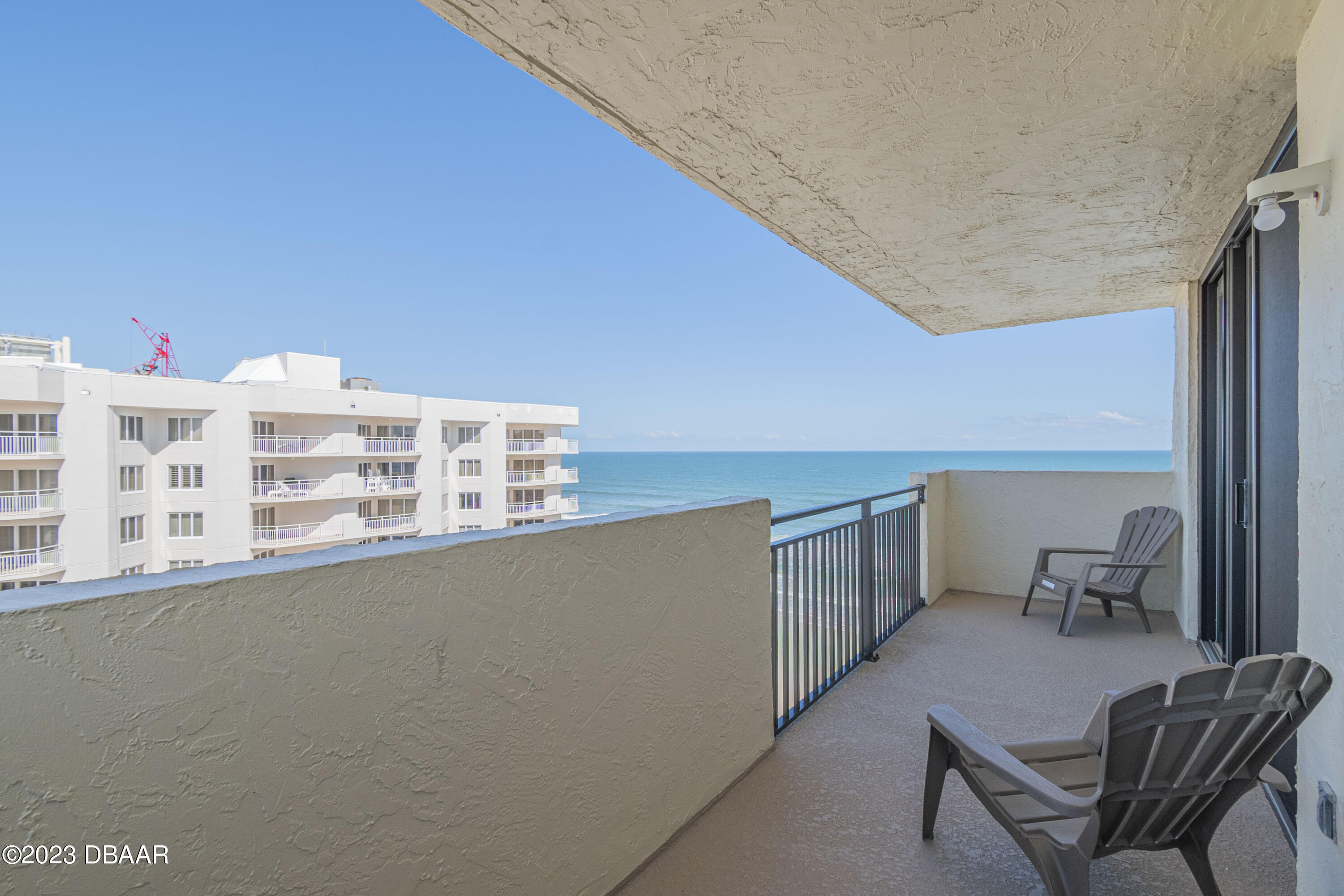 a balcony with table and chairs