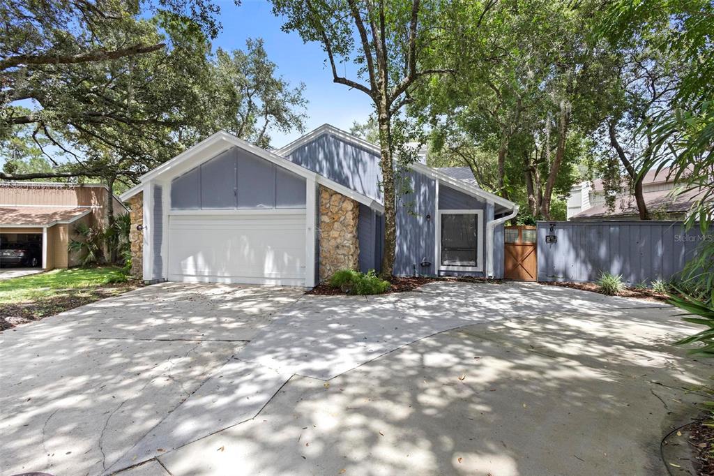 a view of a house with a yard and tree