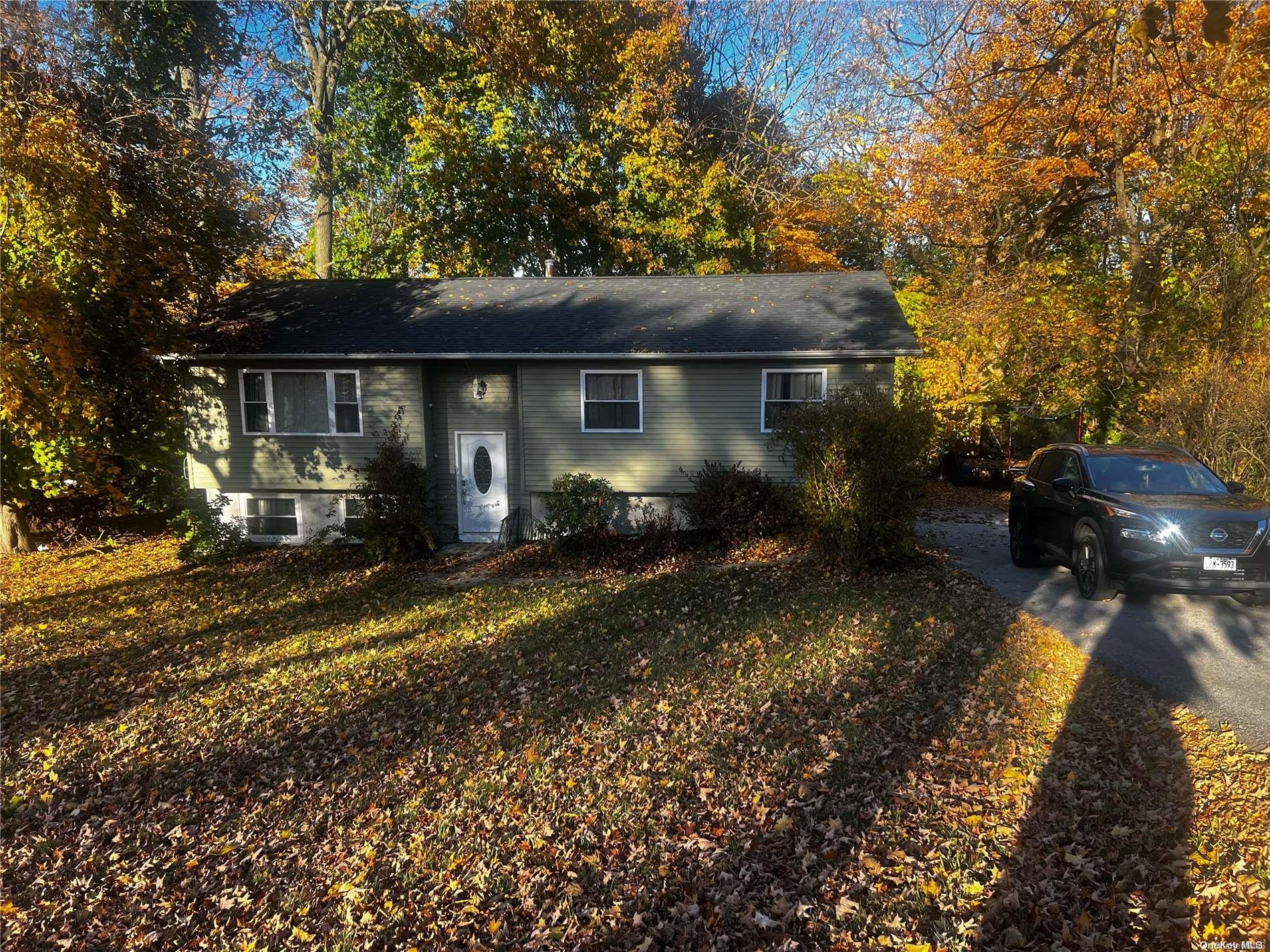 a view of house with yard