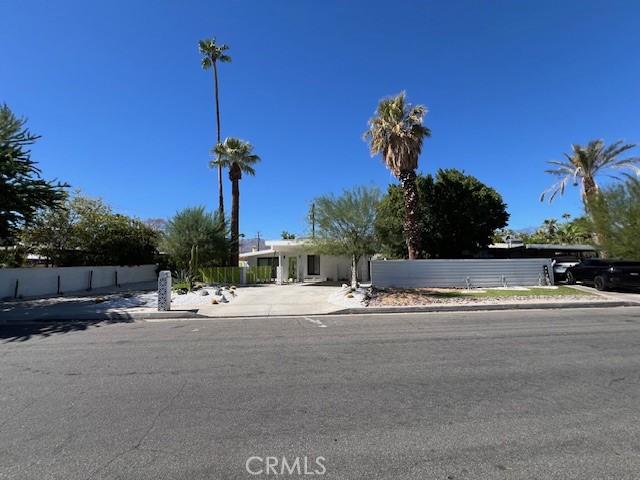 a view of a house with a yard and a car park