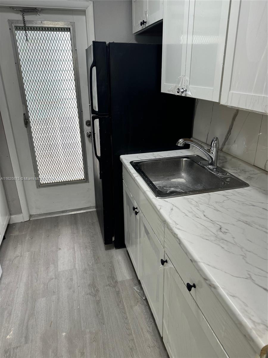 a kitchen with a sink and a refrigerator