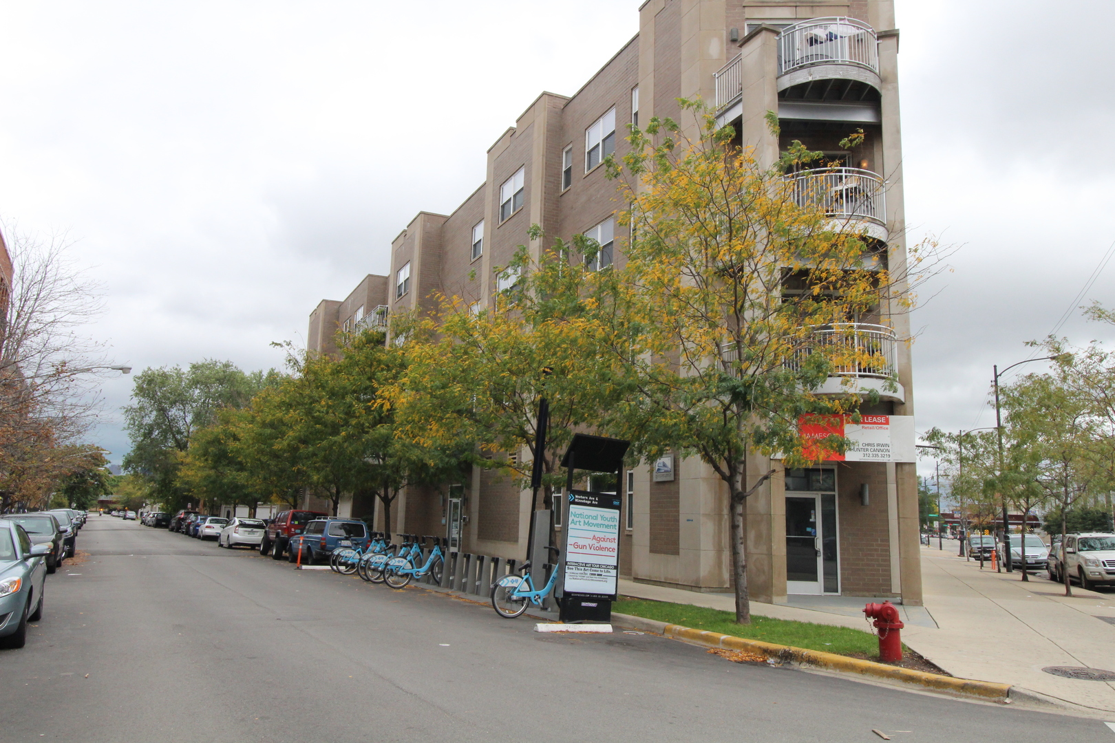 a view of a street with cars parked in front of it