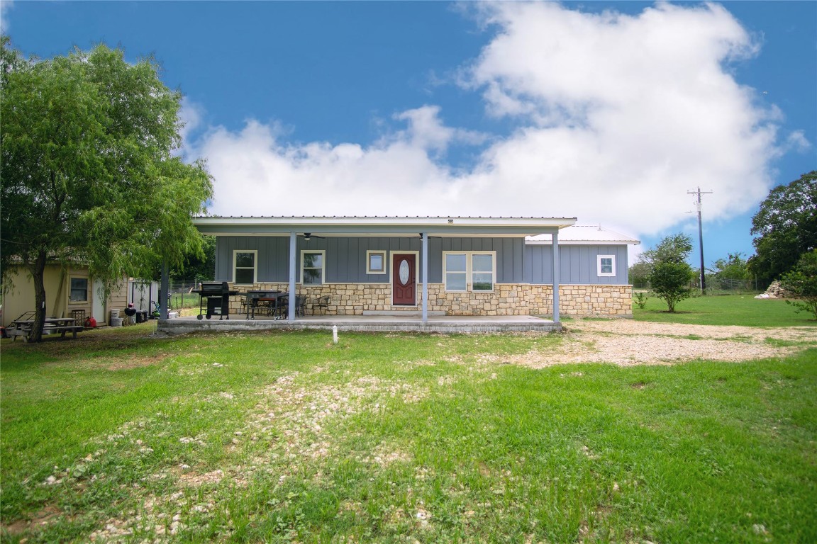 a view of a house with a yard porch and sitting area