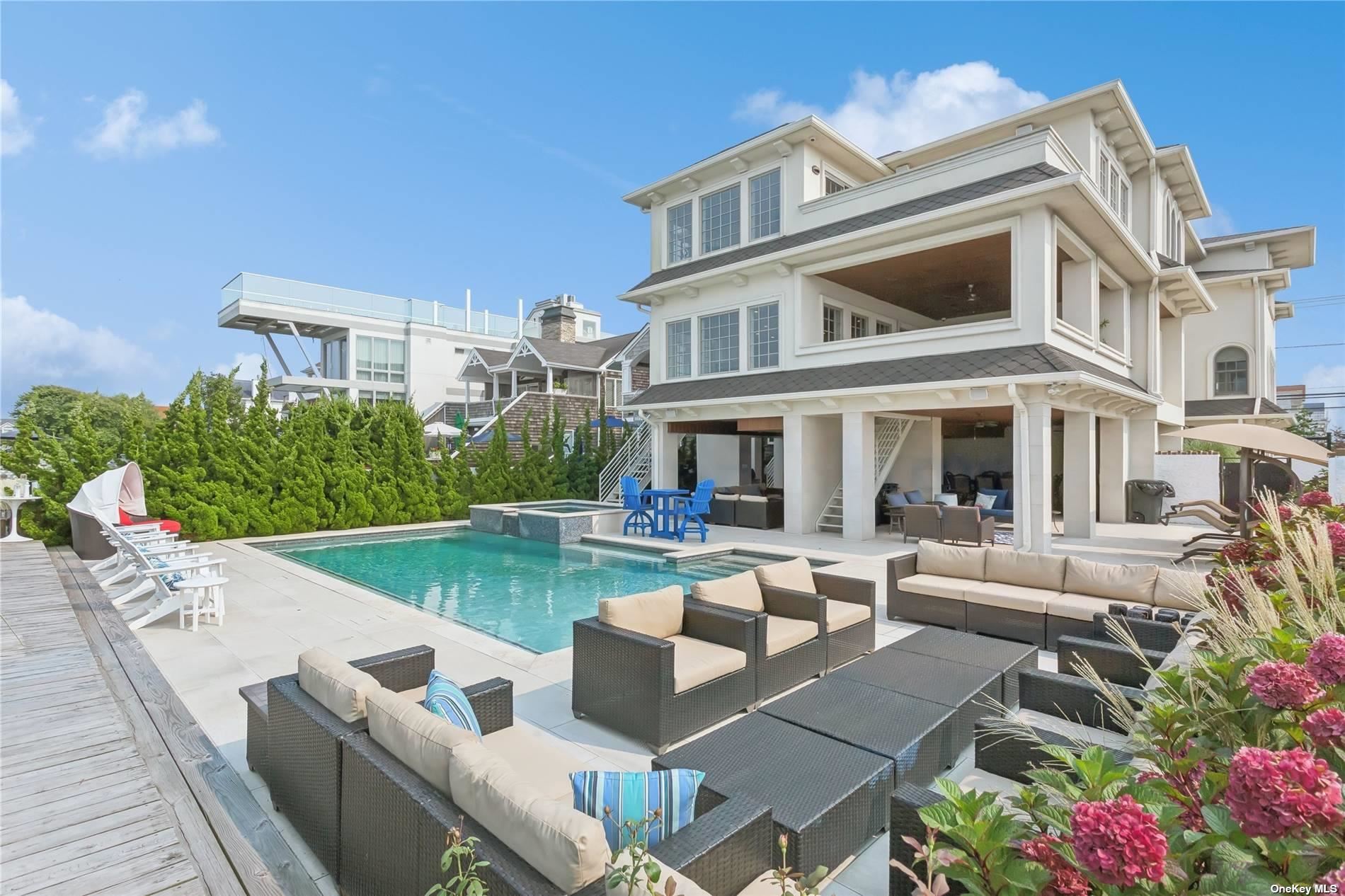 a view of a house with backyard and sitting area