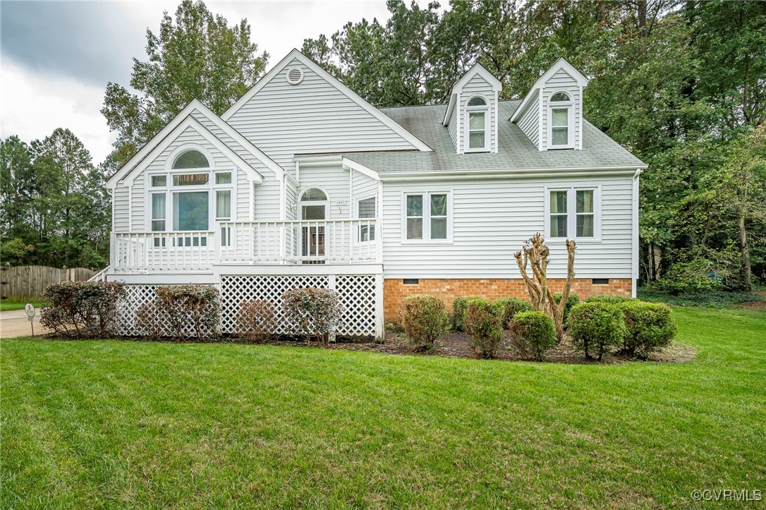 a front view of a house with a garden and plants