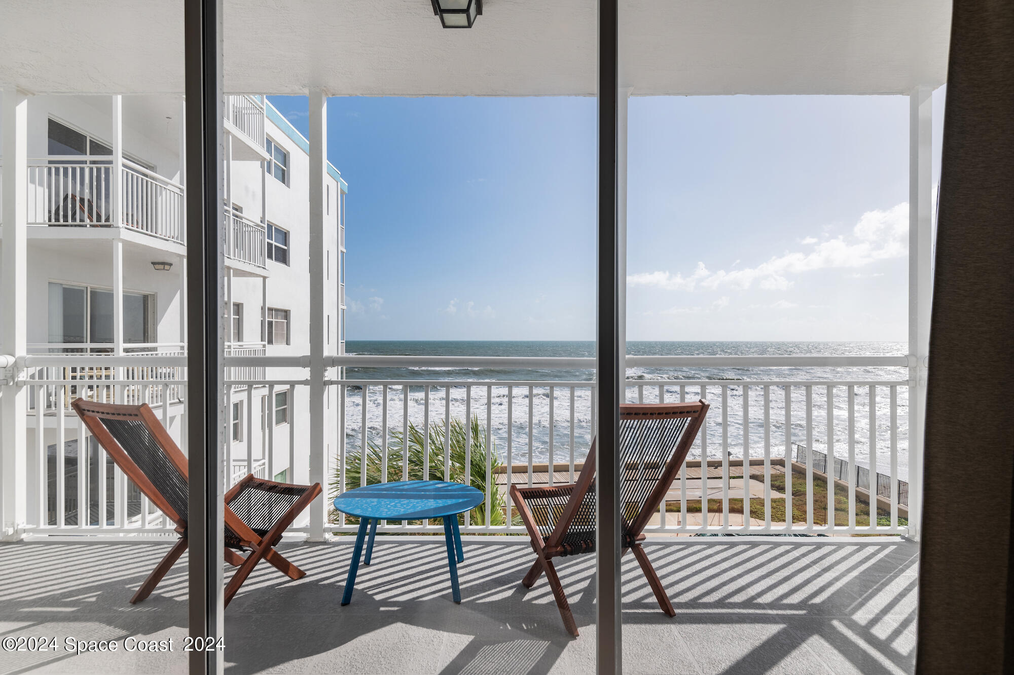 a view of a balcony with chairs