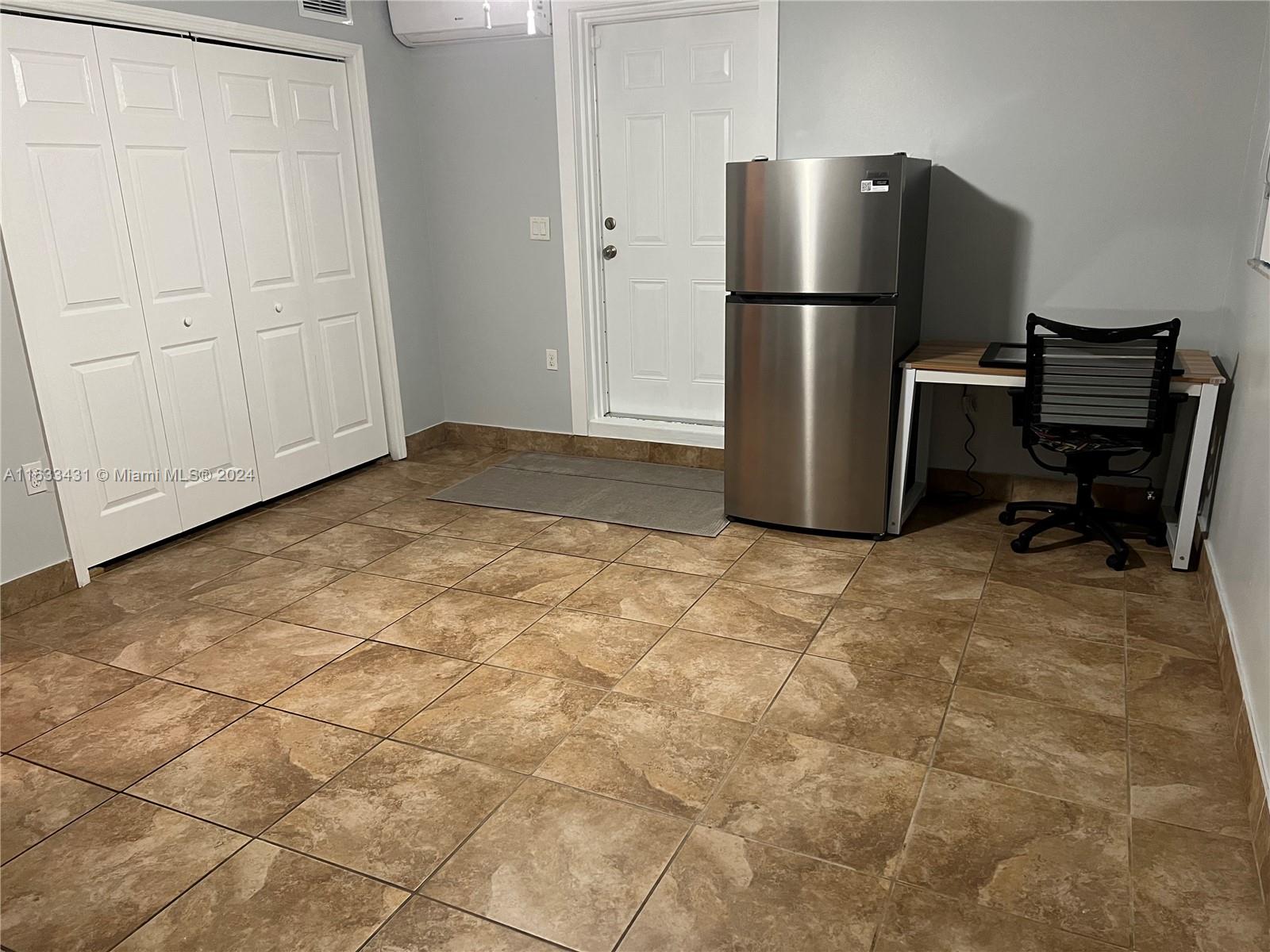 a kitchen with a refrigerator and cabinets