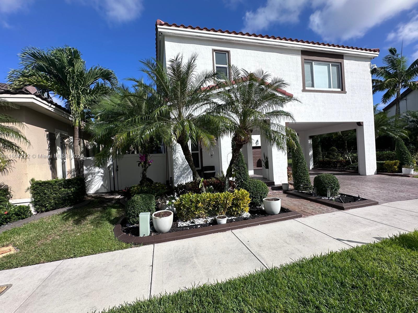 a front view of a house with garden