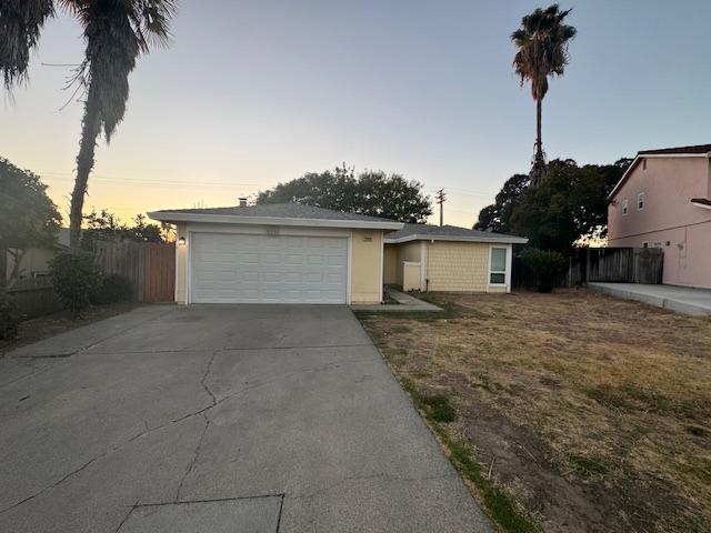 a view of a house with a backyard and a tree