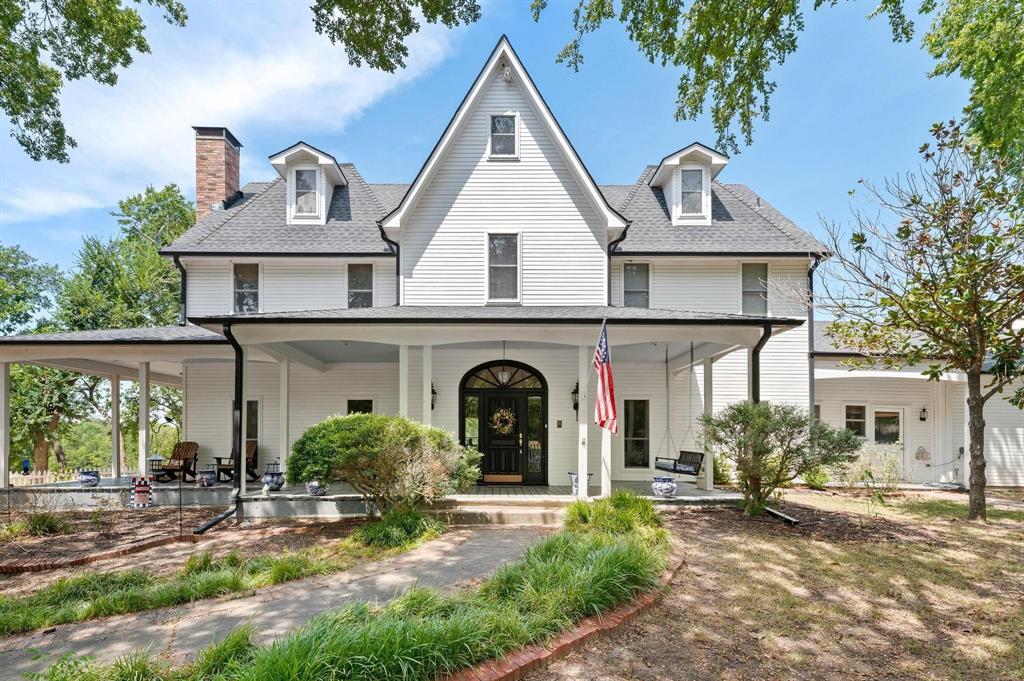 a view of a house with large windows and a yard