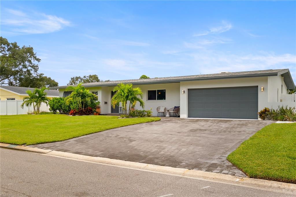 a view of a house with a yard and garage