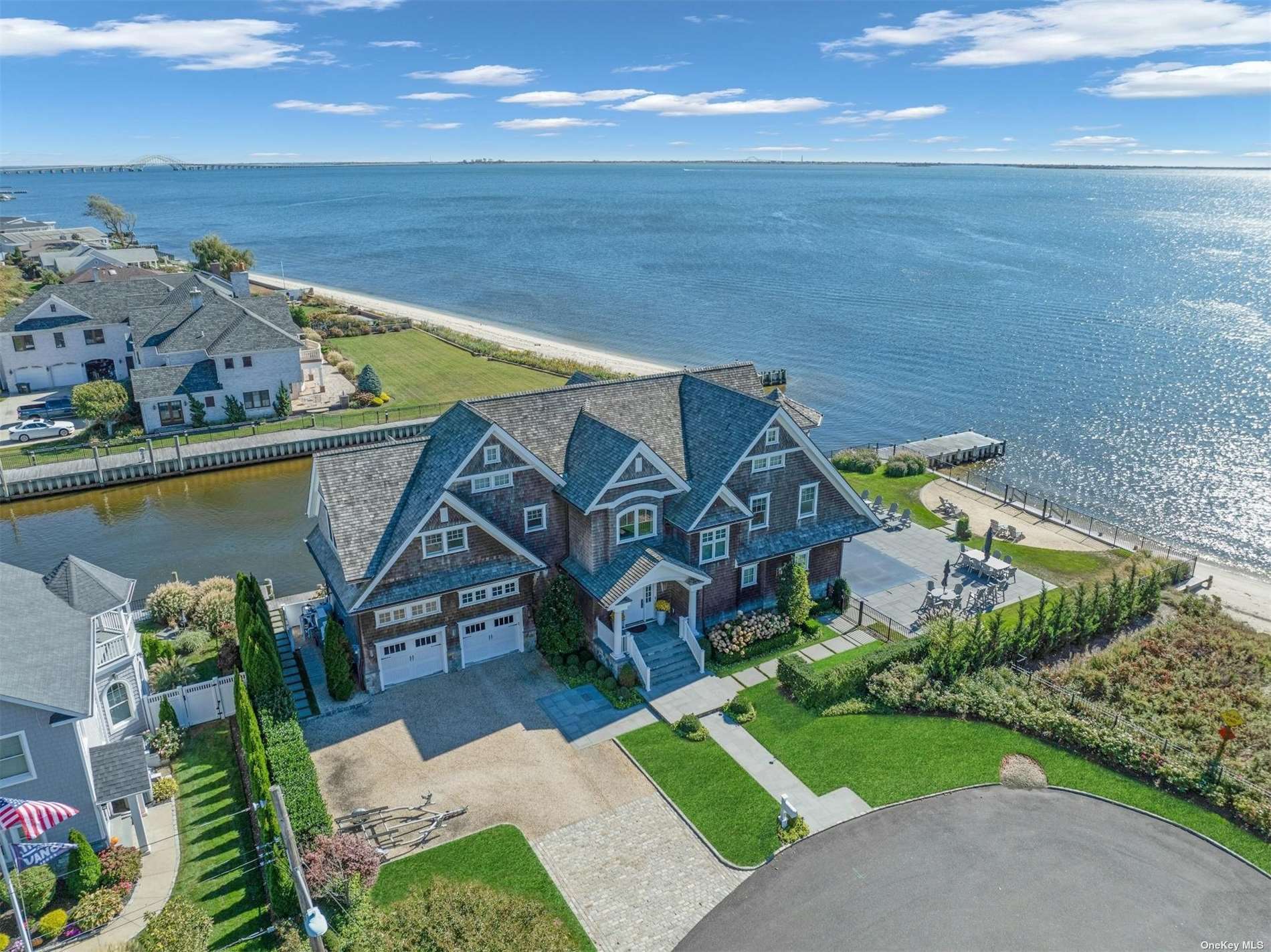 an aerial view of a house with a garden and lake view