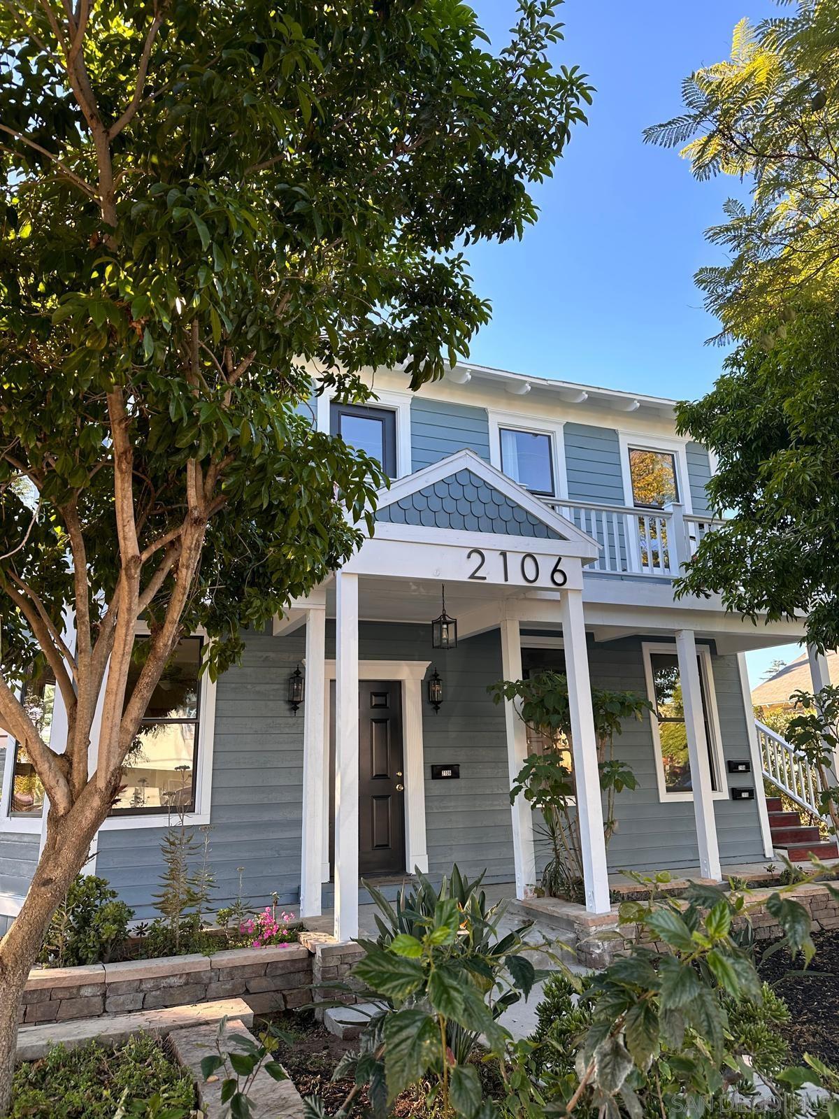 front view of a house with a tree