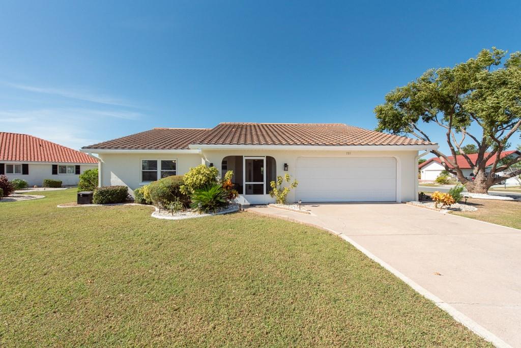 a front view of a house with a yard and garage