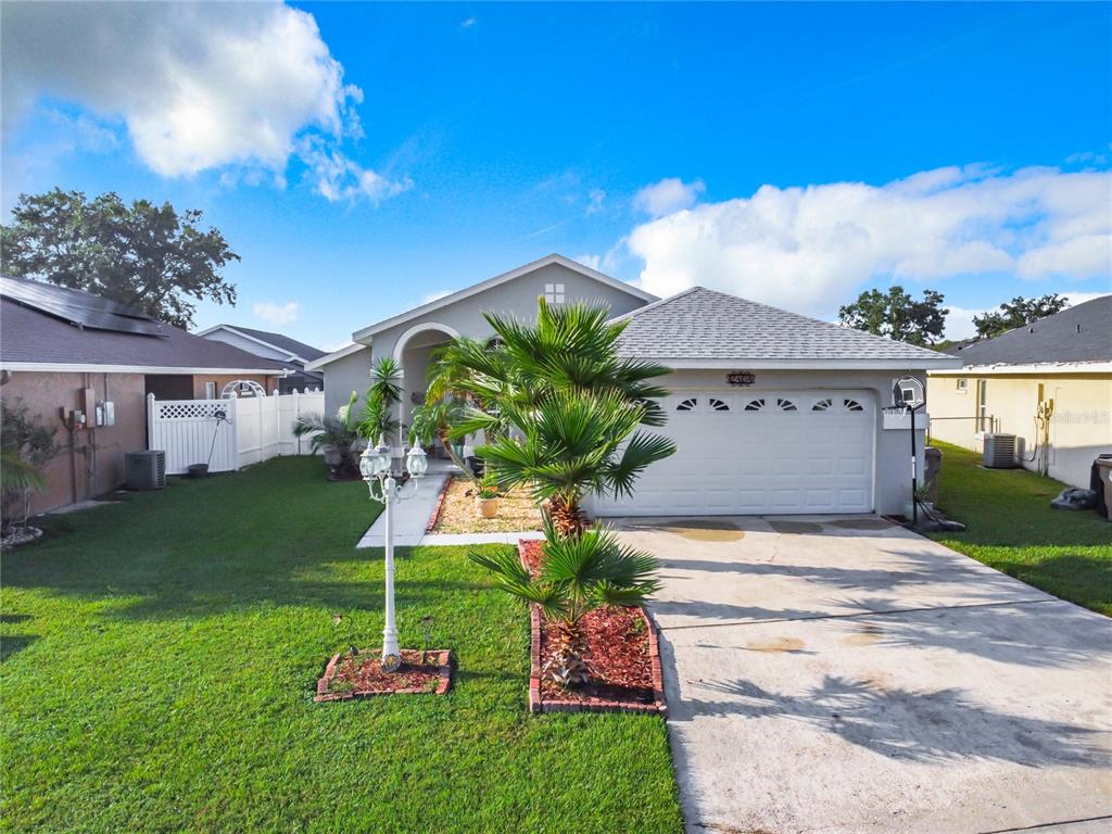 a front view of a house with a yard and a garage