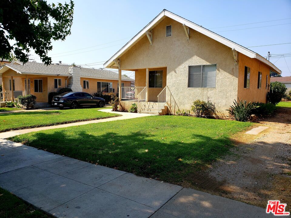 a front view of a house with a yard and porch