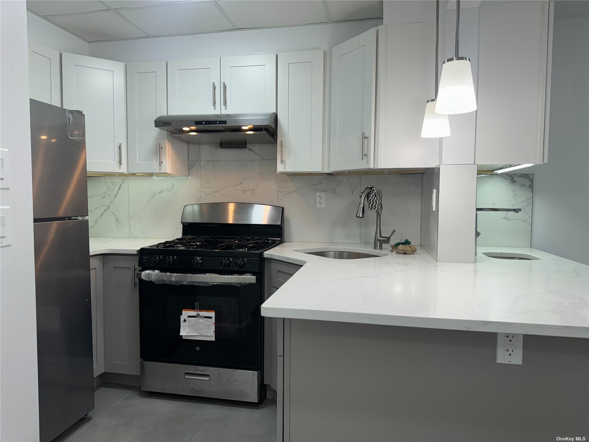 a kitchen with stainless steel appliances a stove and a refrigerator