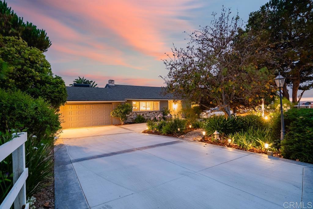 a view of a house with a yard and tree s