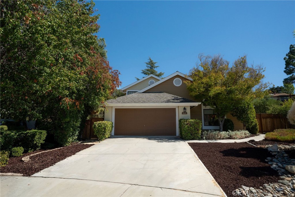 a front view of a house with a yard and potted plants