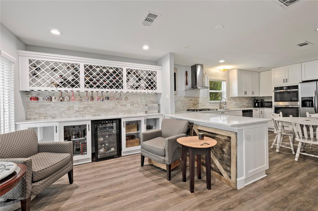 a living room with stainless steel appliances granite countertop furniture and a fireplace