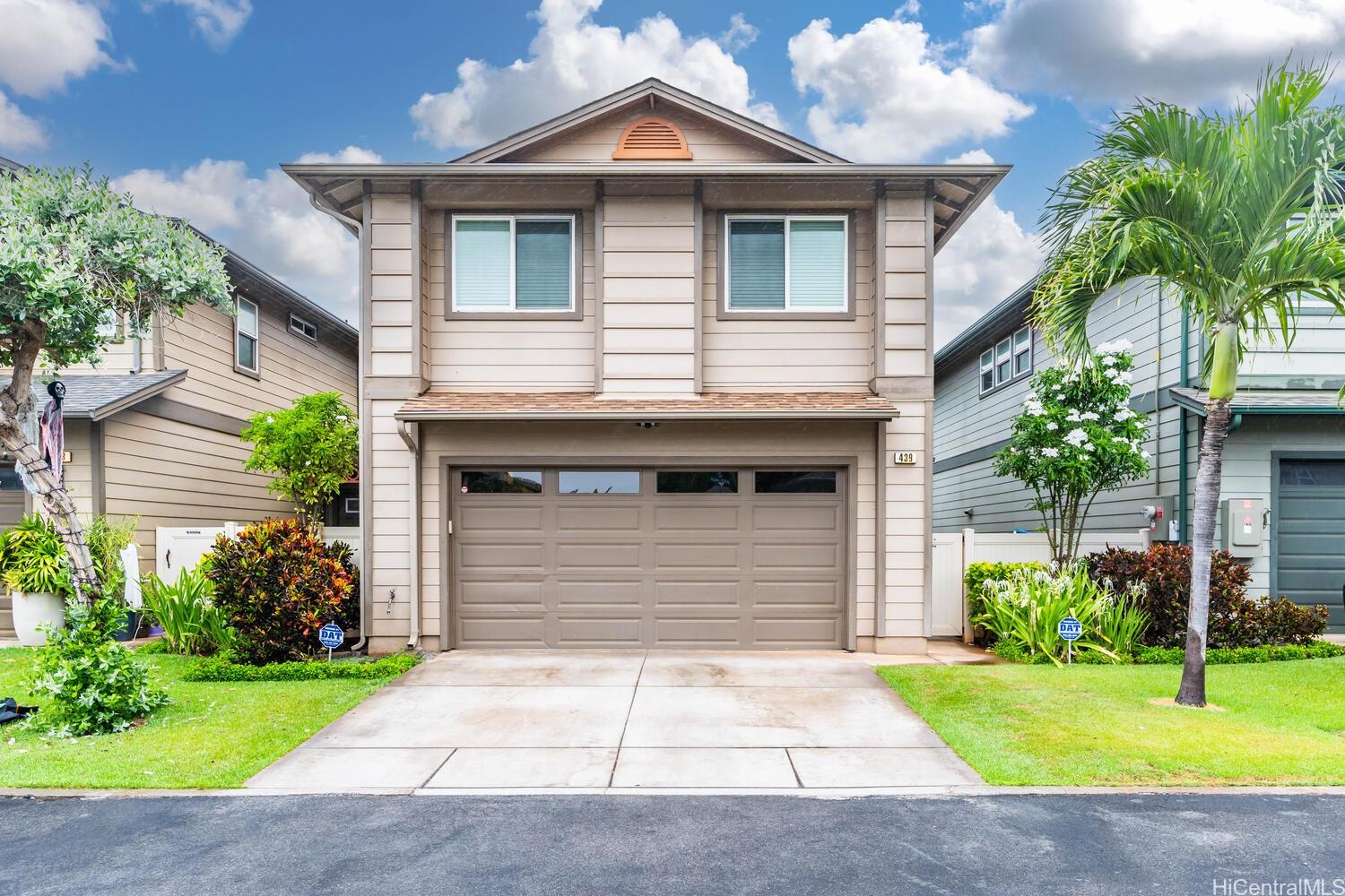 a front view of a house with a yard and garage