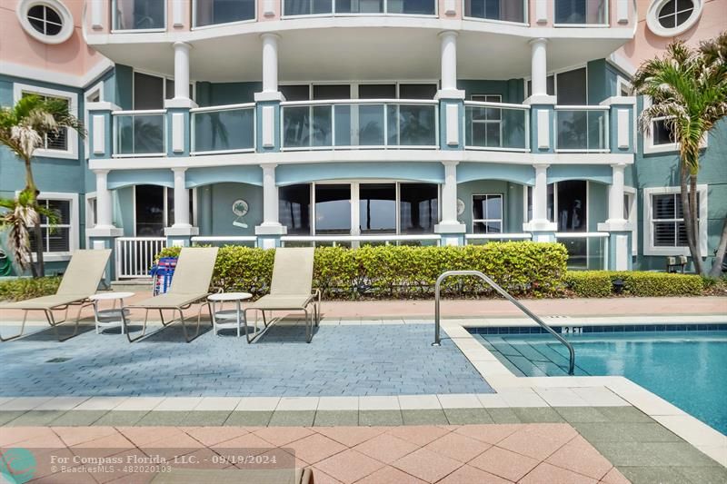 A view from the pool deck showcasing the expansive patio with ample space for relaxation and outdoor activities.