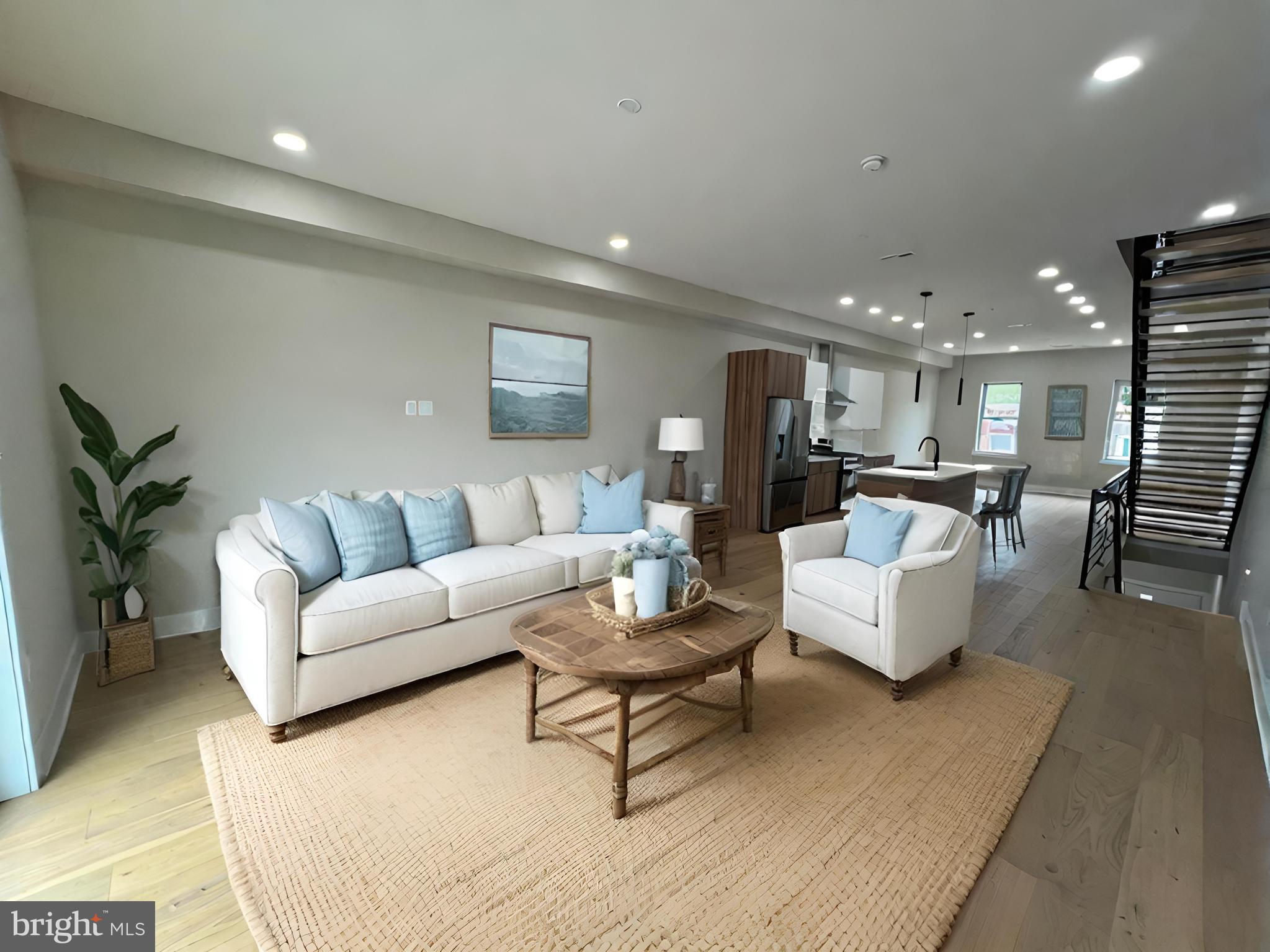 a living room with furniture and view of kitchen