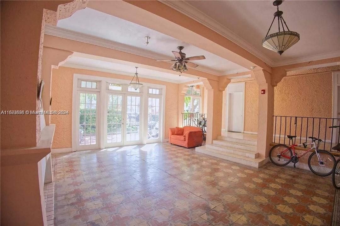 a view of a livingroom with lounge chair and windows