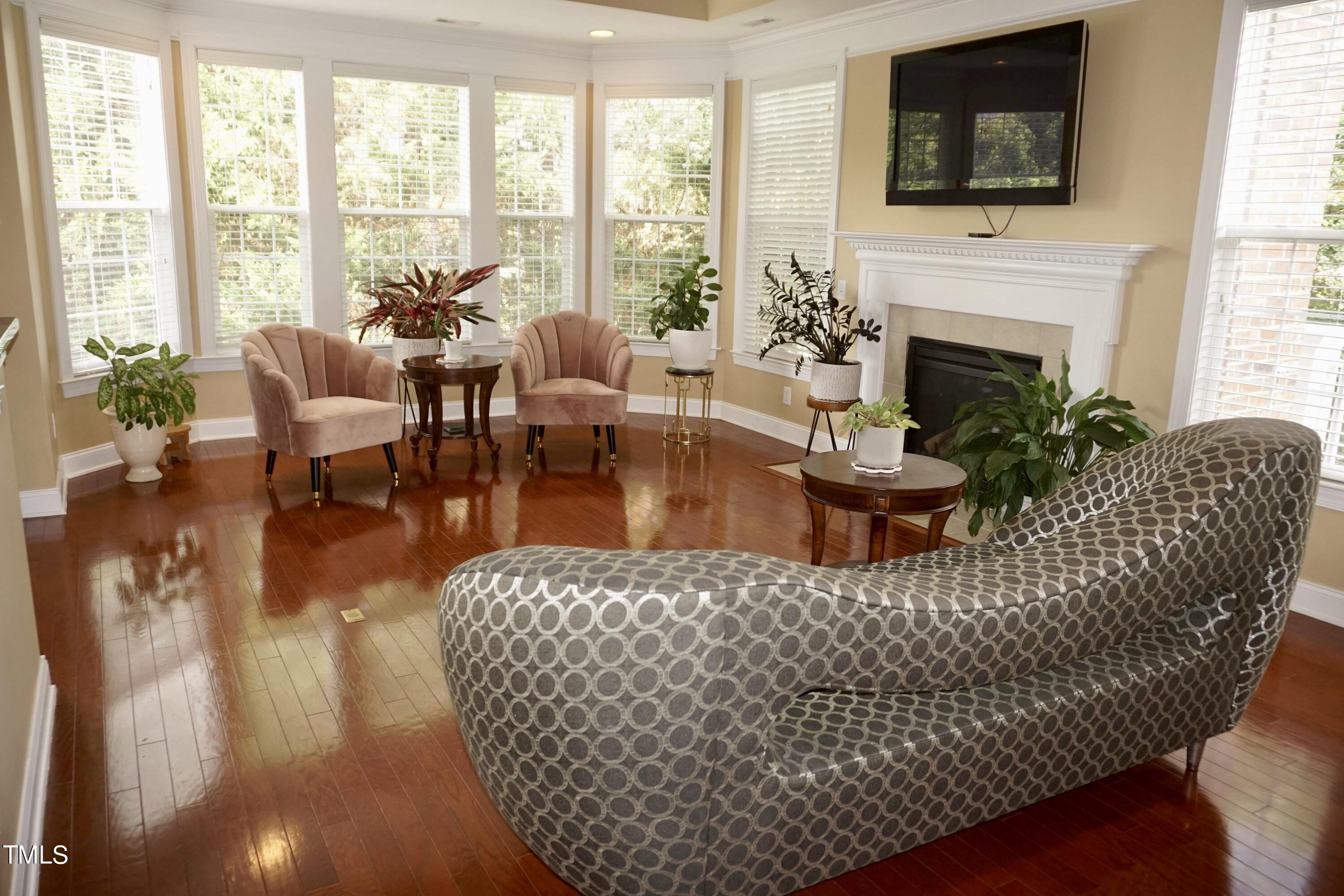 a living room with furniture fireplace and flat screen tv