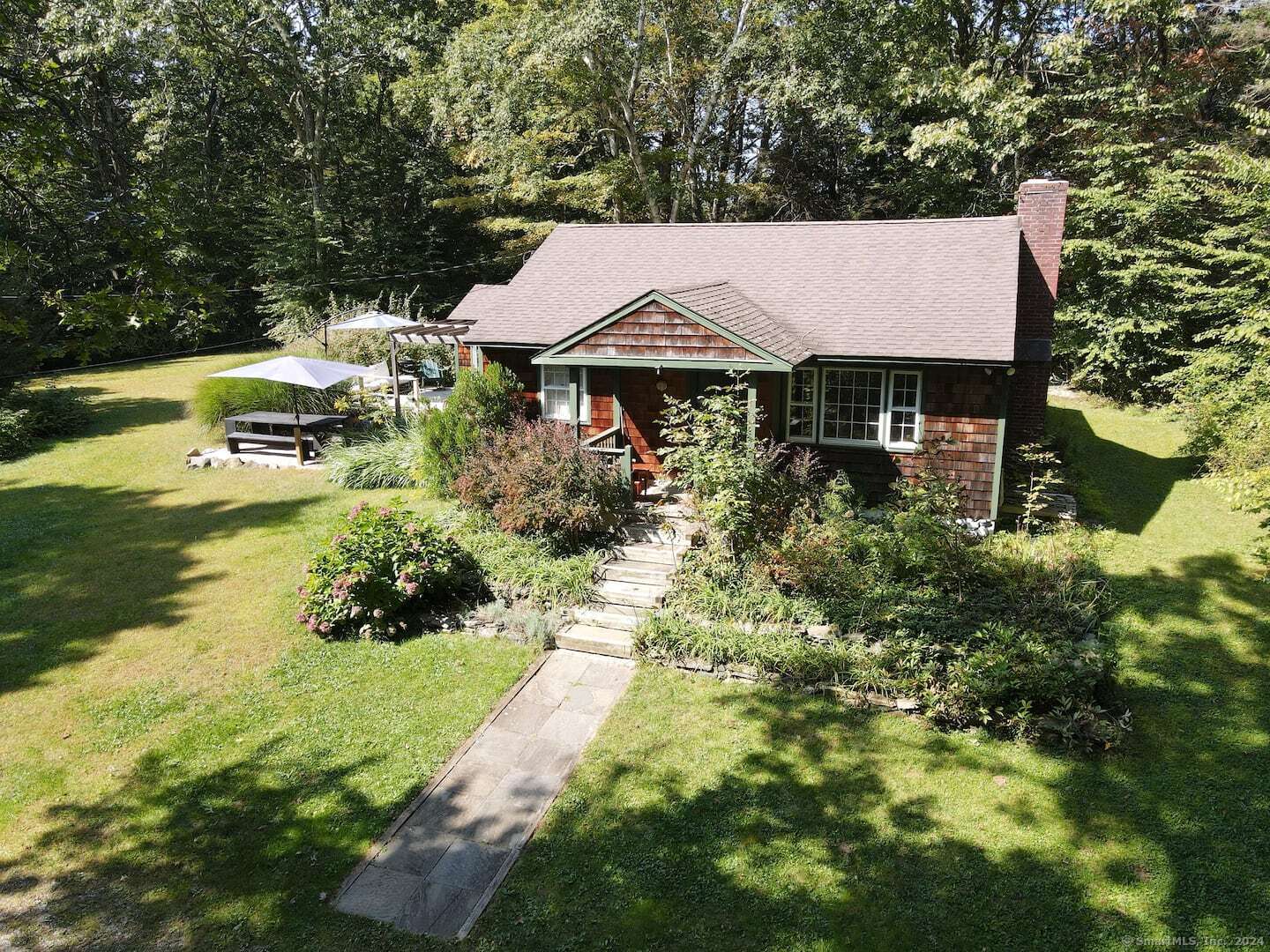 an aerial view of house with yard and trees