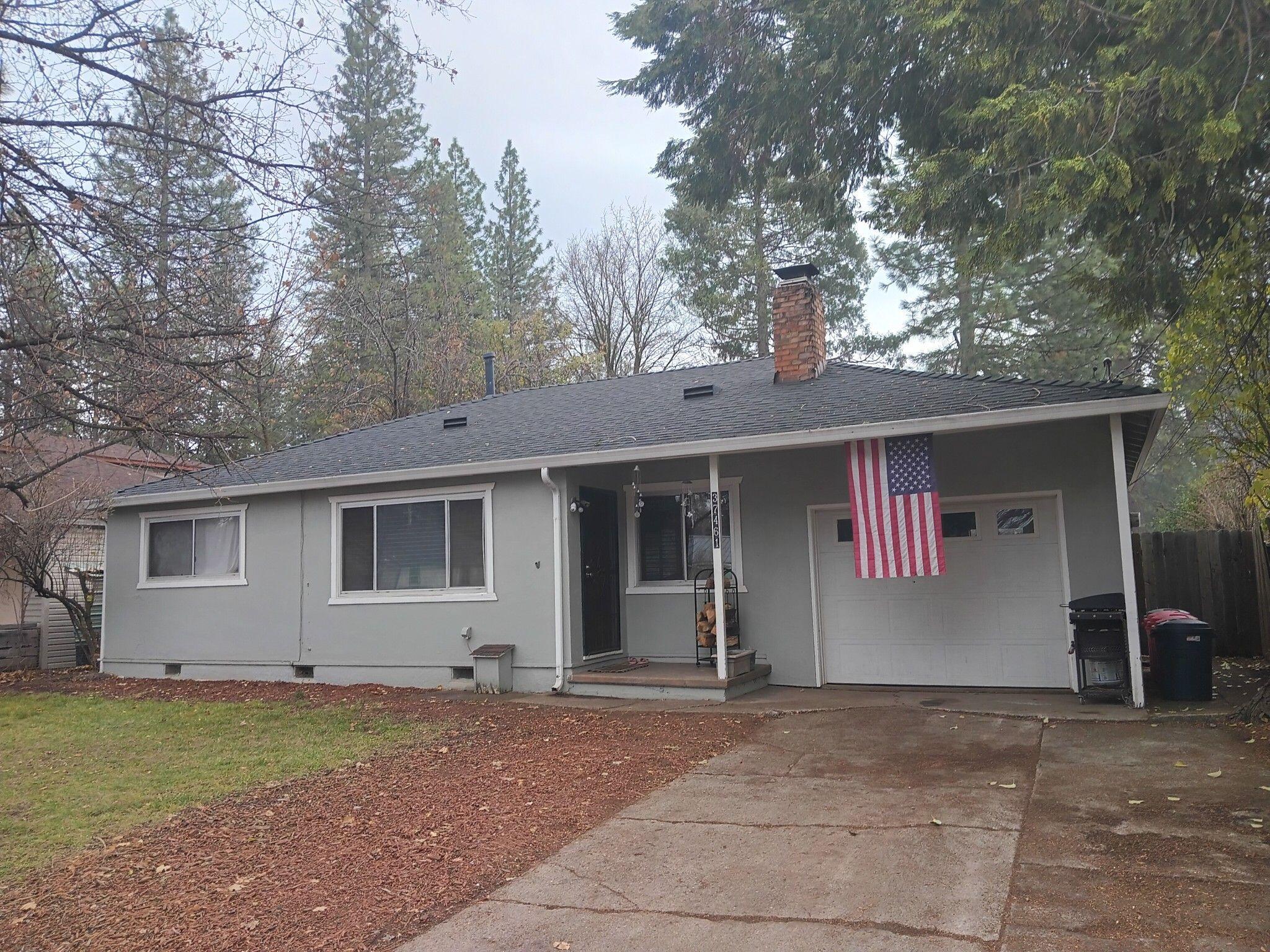 a view of a house with a yard and garage