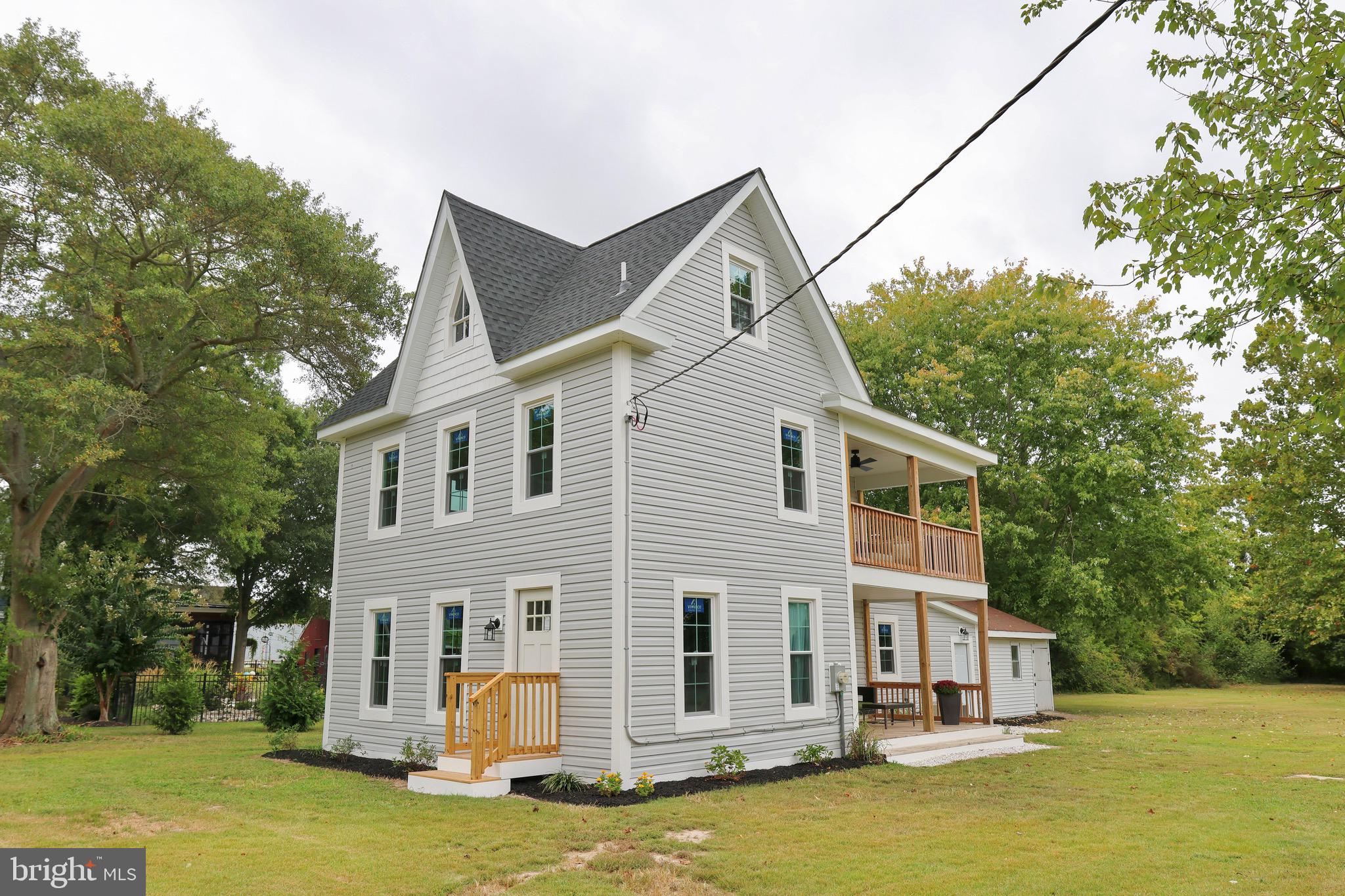 a front view of a house with a yard and balcony