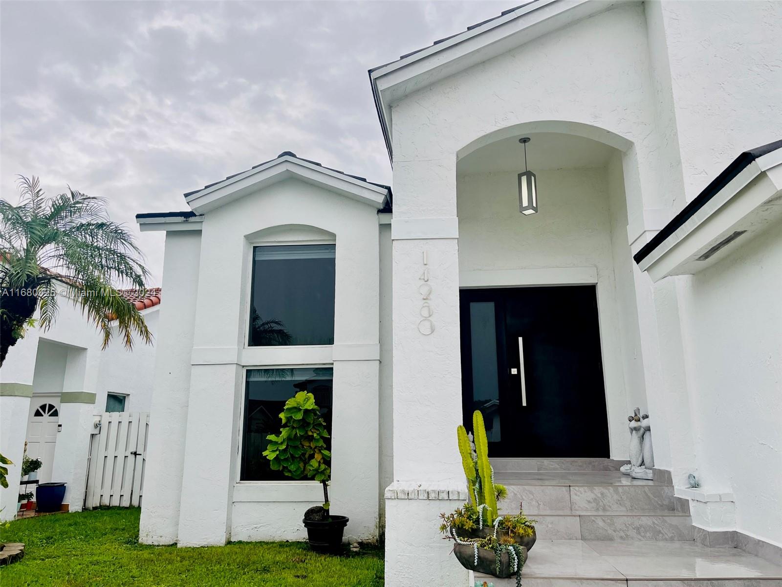 a front view of a house with garden