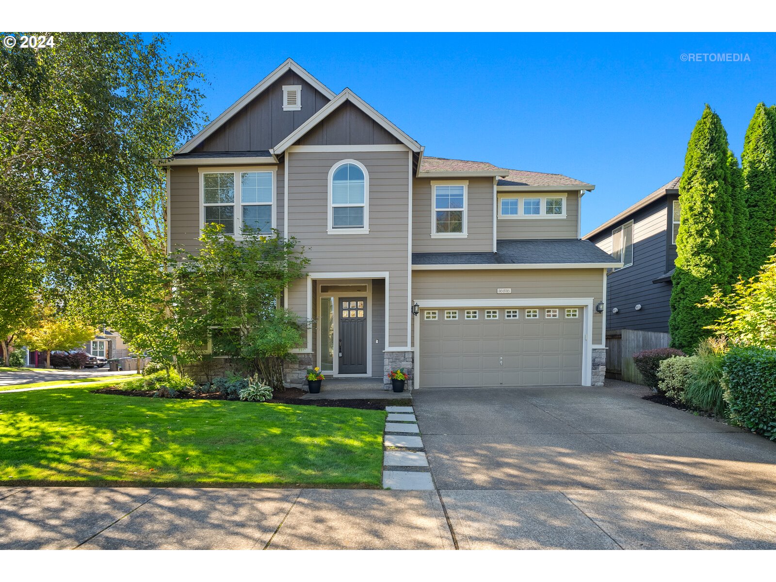 a front view of a house with a yard and garage